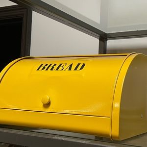 Brand new metal breadbox. Made to look vintage. Yellow w/ black writing.